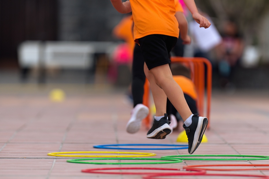 Competitive active game, children jump over obstacles