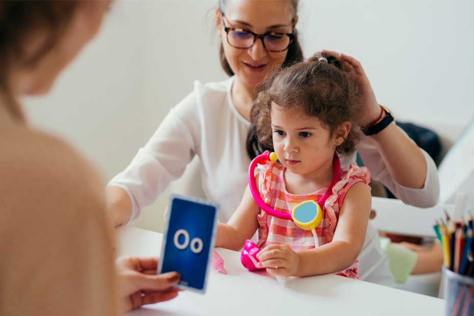 young girl teaching to correct pronouncing words in kindergarden